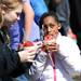 Gabriel Richard freshman Brooke Smith and Holmes elementary schooler Lataysia Logan, 9  enjoy sno-cones during a Washtenaw County Special Olympic field day at at the school on Wednesday, April 17, 2013. Melanie Maxwell I AnnArbor.com